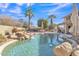 Relaxing pool area with a rock waterfall and patio furniture at 2340 W Myrtle Dr, Chandler, AZ 85248