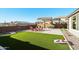 Landscaped backyard with artificial turf and a cornhole game at 25536 S 230Th St, Queen Creek, AZ 85142