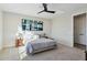 Main bedroom with king bed, ceiling fan and modern art at 25536 S 230Th St, Queen Creek, AZ 85142