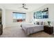 Main bedroom with a king bed, ceiling fan, and large window at 25536 S 230Th St, Queen Creek, AZ 85142