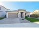 Single-story home with a two-car garage and landscaped front yard at 25536 S 230Th St, Queen Creek, AZ 85142