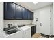 Laundry room with dark cabinets and Whirlpool appliances at 25536 S 230Th St, Queen Creek, AZ 85142