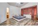 Main bedroom with gray bedding and en-suite bathroom at 25875 W St Catherine Ave, Buckeye, AZ 85326