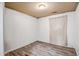 Simple bedroom with wood-look tile flooring and window at 25875 W St Catherine Ave, Buckeye, AZ 85326