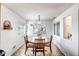 Bright dining area with a round wooden table and four chairs at 25875 W St Catherine Ave, Buckeye, AZ 85326