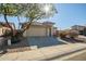 House exterior showcasing a tan facade and a driveway at 25875 W St Catherine Ave, Buckeye, AZ 85326