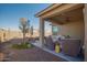 Relaxing covered patio with seating area in the backyard at 25940 W Oraibi Dr, Buckeye, AZ 85396