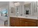 Double vanity bathroom with large mirrors and natural light at 25940 W Oraibi Dr, Buckeye, AZ 85396