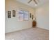 Small bedroom with a window and tiled floors at 25940 W Oraibi Dr, Buckeye, AZ 85396