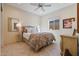 Bright bedroom with a ceiling fan and neutral decor at 25940 W Oraibi Dr, Buckeye, AZ 85396