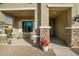 Covered front porch with stone pillars and seating area at 25940 W Oraibi Dr, Buckeye, AZ 85396