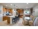 Eat-in kitchen with island seating and a glass-top dining table at 25940 W Oraibi Dr, Buckeye, AZ 85396