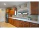 Kitchen with light wood cabinets, stainless steel appliances and ample counter space at 25940 W Oraibi Dr, Buckeye, AZ 85396