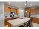 Modern kitchen with island, stainless steel appliances, and wood cabinets at 25940 W Oraibi Dr, Buckeye, AZ 85396