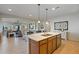 Open concept kitchen with island and a view into the adjacent living room at 25940 W Oraibi Dr, Buckeye, AZ 85396