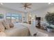 Spacious main bedroom with large windows, a ceiling fan, and ensuite access at 25940 W Oraibi Dr, Buckeye, AZ 85396