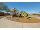 Modern playground with slides and shade structure at 25940 W Oraibi Dr, Buckeye, AZ 85396