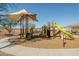 Modern playground with shaded area, slides, and climbing structures at 25940 W Oraibi Dr, Buckeye, AZ 85396