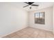 Well-lit bedroom featuring tiled floors and a window with blinds at 2605 S 80Th Ave, Phoenix, AZ 85043