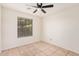 Bedroom with tiled floors and window with blinds at 2605 S 80Th Ave, Phoenix, AZ 85043