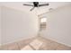 Simple bedroom with ceiling fan and window with blinds at 2605 S 80Th Ave, Phoenix, AZ 85043