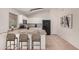 Kitchen with white cabinets, black appliances, and an island at 2605 S 80Th Ave, Phoenix, AZ 85043