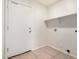 Laundry room with shelving and exterior access at 2605 S 80Th Ave, Phoenix, AZ 85043