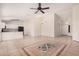 Open concept living area with tile floors and kitchen access at 2605 S 80Th Ave, Phoenix, AZ 85043