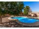 Inviting kidney-shaped pool surrounded by a gravel patio at 2605 S 80Th Ave, Phoenix, AZ 85043