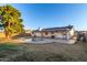 Home's back elevation with a large pool and mature trees at 2618 W Surrey Ave, Phoenix, AZ 85029