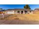 Brick house with a two-car garage and a well-maintained lawn at 2618 W Surrey Ave, Phoenix, AZ 85029