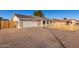 Front view of a single-story home with a white garage door at 2618 W Surrey Ave, Phoenix, AZ 85029