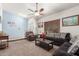 Spacious living room with a ceiling fan and large windows at 2618 W Surrey Ave, Phoenix, AZ 85029