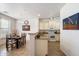 Kitchen and dining area with granite counters and light cabinets at 2757 S Pewter Dr # 103, Gilbert, AZ 85295