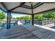 Covered gazebo with wooden deck overlooking a lake at 2757 S Pewter Dr # 103, Gilbert, AZ 85295