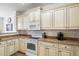 Well-equipped kitchen with granite countertops and light wood cabinets at 2757 S Pewter Dr # 103, Gilbert, AZ 85295