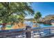 Serene lakefront view with lush landscaping and trees at 2757 S Pewter Dr # 103, Gilbert, AZ 85295