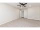 Well-lit bedroom with ceiling fan and carpet flooring at 2818 N 90Th Ave, Phoenix, AZ 85037