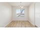 Bright dining room with a window and wood-look floors at 2818 N 90Th Ave, Phoenix, AZ 85037