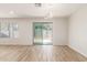 Spacious dining area with wood-look flooring and access to backyard at 2818 N 90Th Ave, Phoenix, AZ 85037