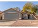 One-story home with a two-car garage and gravel landscaping at 2818 N 90Th Ave, Phoenix, AZ 85037