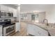 Modern kitchen with stainless steel appliances and white cabinets at 2818 N 90Th Ave, Phoenix, AZ 85037