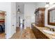 Elegant bathroom with dual vanities, a large mirror, and a walk-in closet at 28602 N 58Th St, Cave Creek, AZ 85331