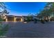 Elegant single-story home with a large driveway and landscaped yard at dusk at 28602 N 58Th St, Cave Creek, AZ 85331