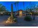 Desert home exterior at night, beautifully lit landscaping at 28602 N 58Th St, Cave Creek, AZ 85331