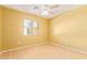 Bright bedroom with ceiling fan and laminate wood flooring at 2875 S Key Biscayne Dr, Gilbert, AZ 85295