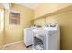 Laundry room with washer, dryer, and overhead shelving at 2875 S Key Biscayne Dr, Gilbert, AZ 85295