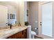 Powder room with granite vanity and private door at 28821 N Ashbrook Ln, Queen Creek, AZ 85144