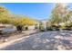 Front yard with paved driveway and mature trees at 28821 N Ashbrook Ln, Queen Creek, AZ 85144