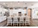 Modern kitchen with white cabinets, granite countertops, and island seating at 28821 N Ashbrook Ln, Queen Creek, AZ 85144